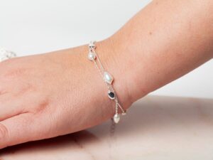 Vrouw met parel armband om pols Bracelet Pearl Athena 925 sterling zilver en zoetwaterparel Laura Design